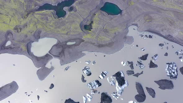 Aerial View of Floating Icebergs. Solheimajokull Melting Glacier Ice Cap, Iceland