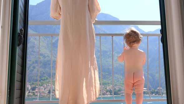 Baby Toddler Boy Standing with Mother on Balcony at Tropical Beach Resort
