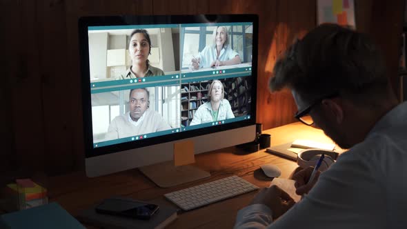 Businessman Having Virtual Team Meeting on Video Conference Call Using Computer