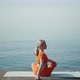 A Woman in a Lotus Position Does an Asana Turns to the Right - VideoHive Item for Sale