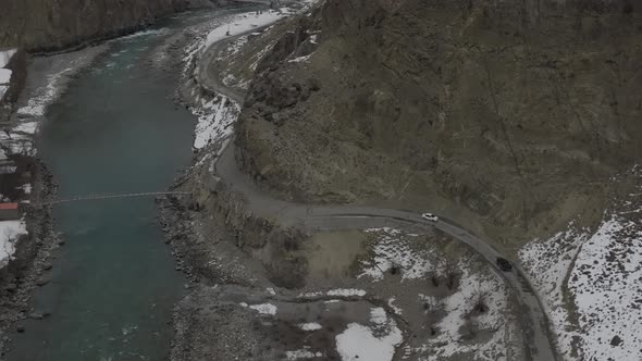 Drone shot of Altit fort in Hunza Valley with turquoise river and autumn forest