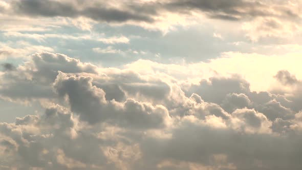 Time lapse of clouds over rural landscape with green hills