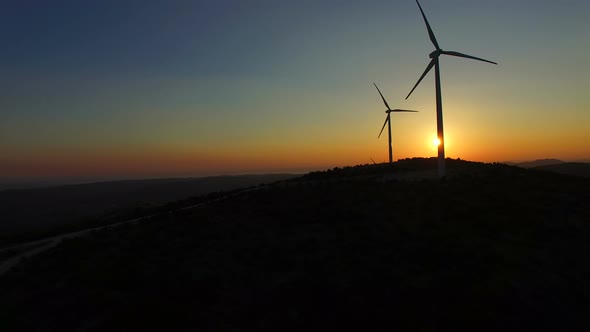 Close up of rotating windmill blades at sunset