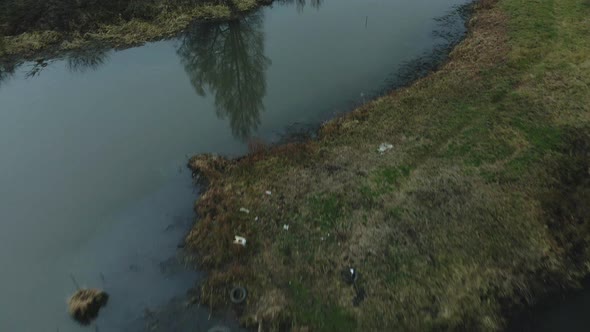 The river among the city park. Late autumn, cloudy.