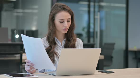 Young Businesswoman With Laptop Reacting to Failure on Documents