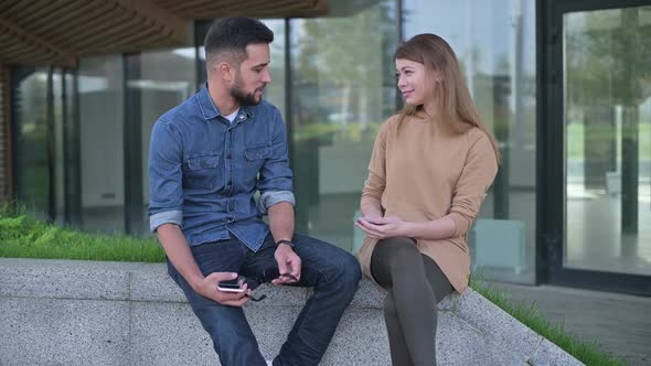 Meeting of two young people - a man and a woman in the park. Date in the park