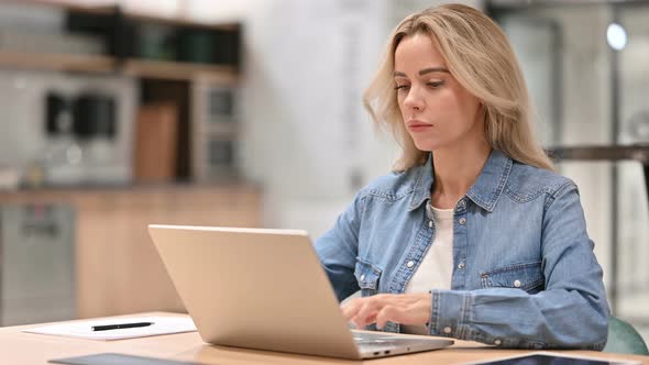 Young Casual Woman at Work Using Laptop 