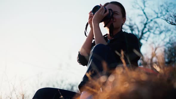 A Young Beautiful Woman Traveler Taking a Picture with Her Camera