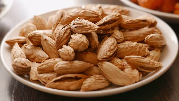 Almonds Nuts with Shell in a White Plate