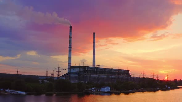 Industrial zone against pink sky at sunset