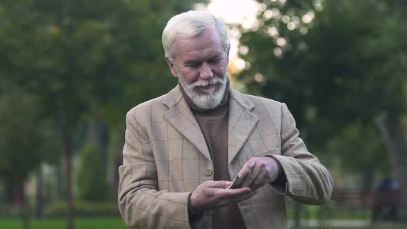 Happy Male Pensioner Throwing Around Dollar Bills, Lottery Luck, Investment