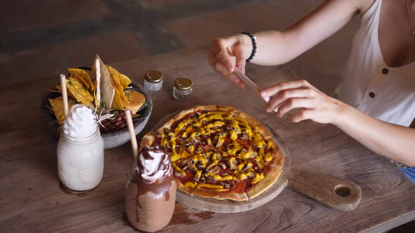 Top View of Hands Taking Picture of Vegan Lunch Consisted of Pizza Nachos and Milkshakes in Glass