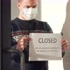 Owner of the Institution in a Medical Mask Hangs a Closed Sign on the Door - VideoHive Item for Sale