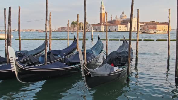 Docked Empty Gondolas on Wooden Mooring Piles Venice Italy