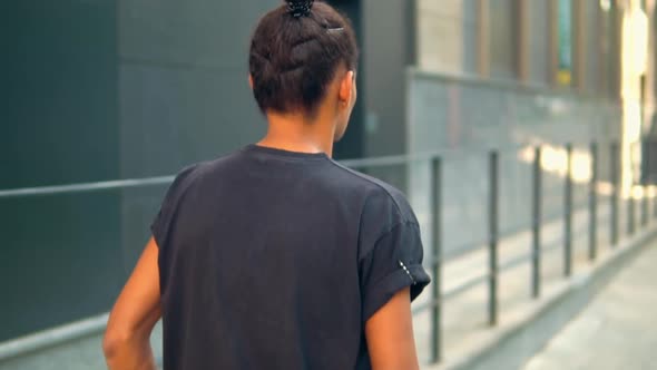 Unrecognizable Young Man Going on the Street