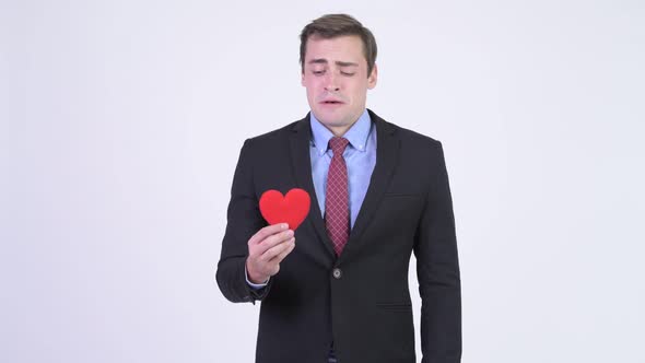 Young Heart Broken Businessman Holding Red Heart