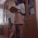 Education Stock Footage 4 K Ultra Hd Clips   A Woman Reading A Book While Leaning On A Bookshelf - VideoHive Item for Sale