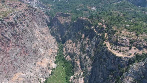 Deep and Steep Rocky Canyon Walls With Narrow Long Valley