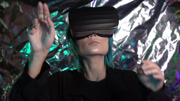 A Modern Man or Woman Wearing Virtual Reality Glasses Makes Hand Gestures