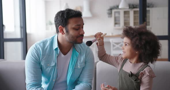 Mixed Race Little Daughter Does Makeup on Latin Father Face