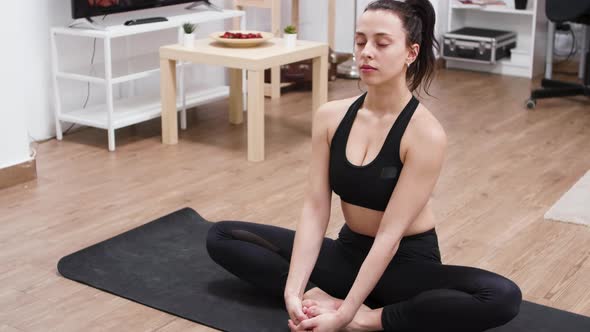 Pretty White Woman Doing Lotus Yoga Pose on Mat