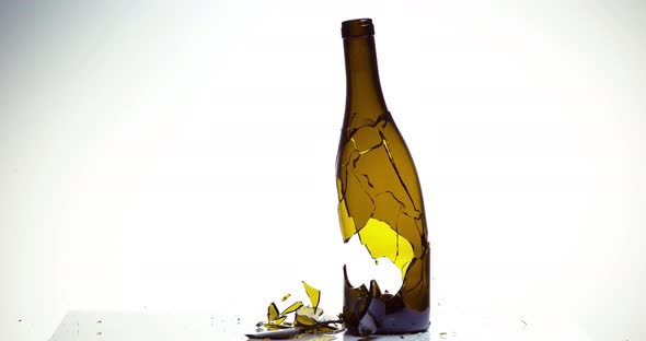 900085 Bottle of White Wine Breaking and Splashing against White Background, Slow motion 4K