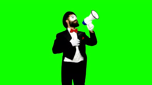 Man Mime Uses Speaker and Cries Something To Somebody on Green Screen