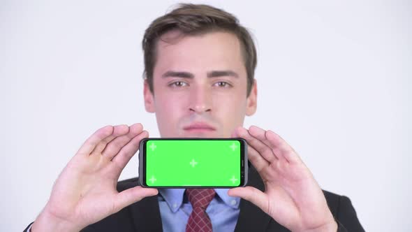 Young Happy Handsome Businessman Showing Phone