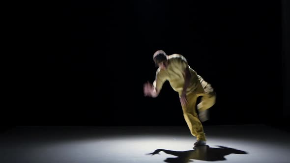 Breakdance Dancer in Yellow Suit Starts Dance on Black, Shadow