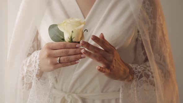 Lovely Bride in Wedding Luxury Boudoir Dress Night Gown with Wedding Bouquet for Groom in the Hands