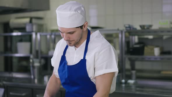 Portrait of Burnt Out Caucasian Handsome Bearded Young Man in Cook Uniform Sighing Rubbing Forehead