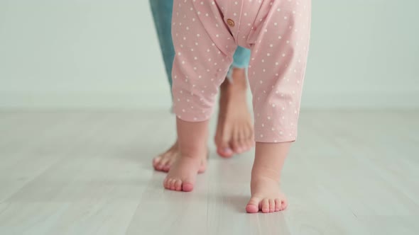 Mom Teaches the Child to Walk