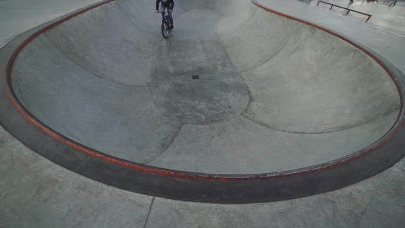 MTB Bicycle Rider Does Various Tricks While Riding in Skatepark 