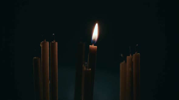 Lit One Candle in a Dark Room, Next To Not Lit Candles