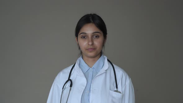 Confident Young Indian Female Doctor Wear White Coat Look at Camera Portrait