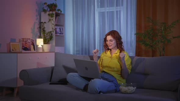 Beautiful Woman Reacts Emotionally While Watching Sports Matches or Playing in Online Casino on