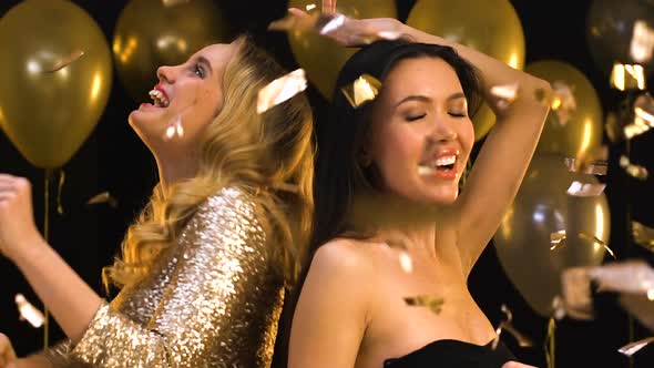 Beautiful Multiracial Women Dancing at Party Under Falling Confetti, Celebration