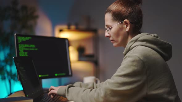 Woman Coding on Multiple Computers