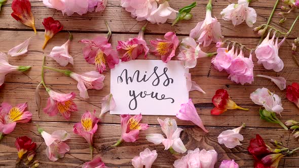 MISS YOU card on a wooden table top view