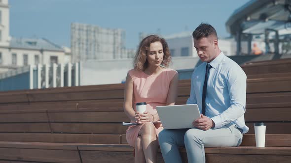 Young colleagues with laptop