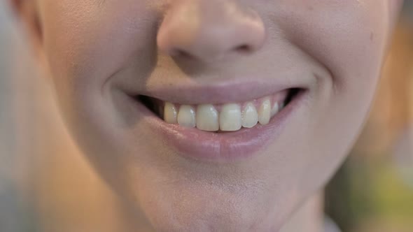 Close Up of Smiling Young Woman Lips and Teeth