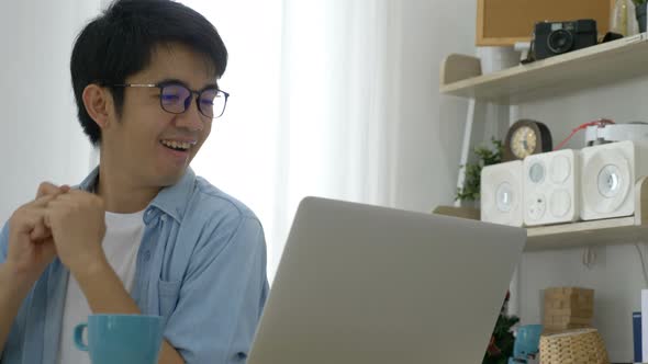 Happy Asian business man dancing in the office success dance.