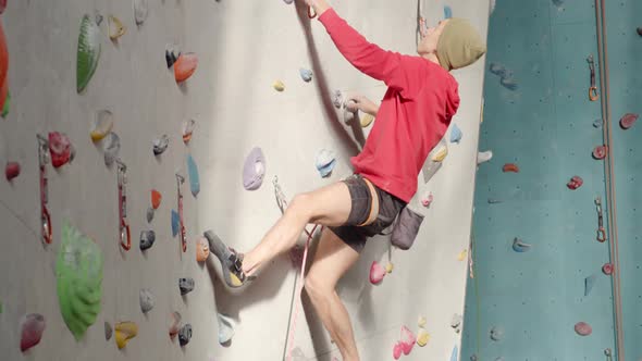 Sporty Young Man Having Workout in Climbing Center