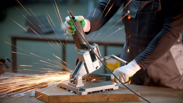 Young Handsome Man Using a Grinder To Cut the Detail