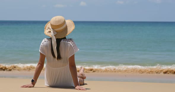 Woman sit on beach enjoy sea view