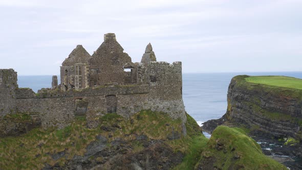 Ruins Of Dunluce Castle In County Antrim, Northern Ireland, UK With A Scenic View Of Blue Ocean And