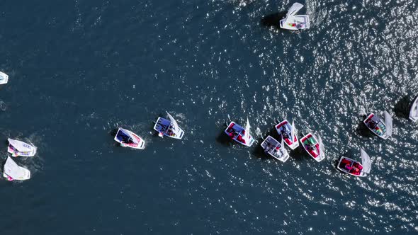 Regatta of small boats on the lake in summer, view from above