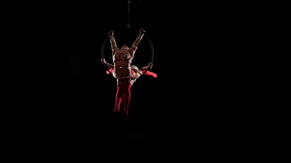 Two Dancer Balancer on Aerial Hoop. Black Background. Slow Motion