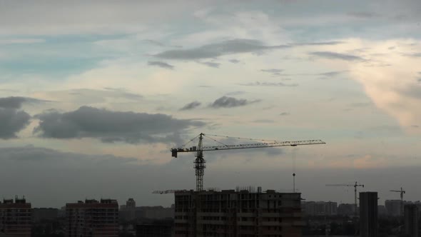 Time Lapse of Construction at Sunset with City in the Background