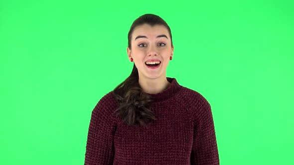 Girl Is Surprised at What Is Happening Around, Looking with Delight and Admiration. Green Screen